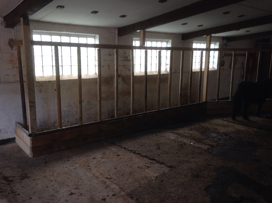 Leerer Pferdestall mit Futterkrippe