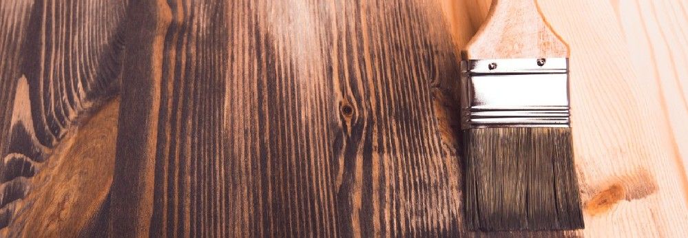 Holz wird lasiert mit einem Pinsel